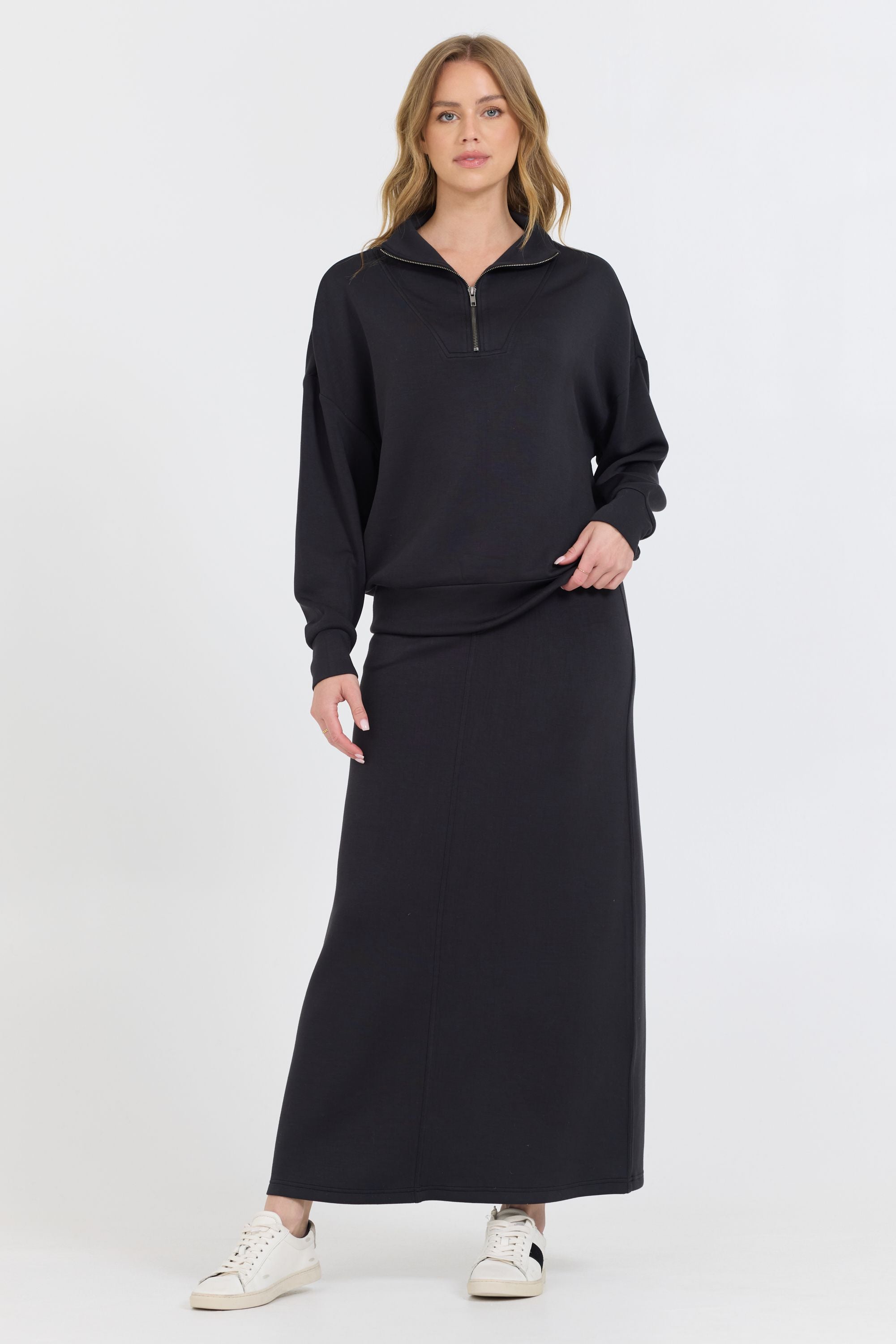 Constructed with a blend of 49% Modal, 45% Polyester, and 6% Spandex, the Black Cloud Fleece Maxi Skirt boasts an ankle-length design that adds a slimming touch to your cozy ensemble.