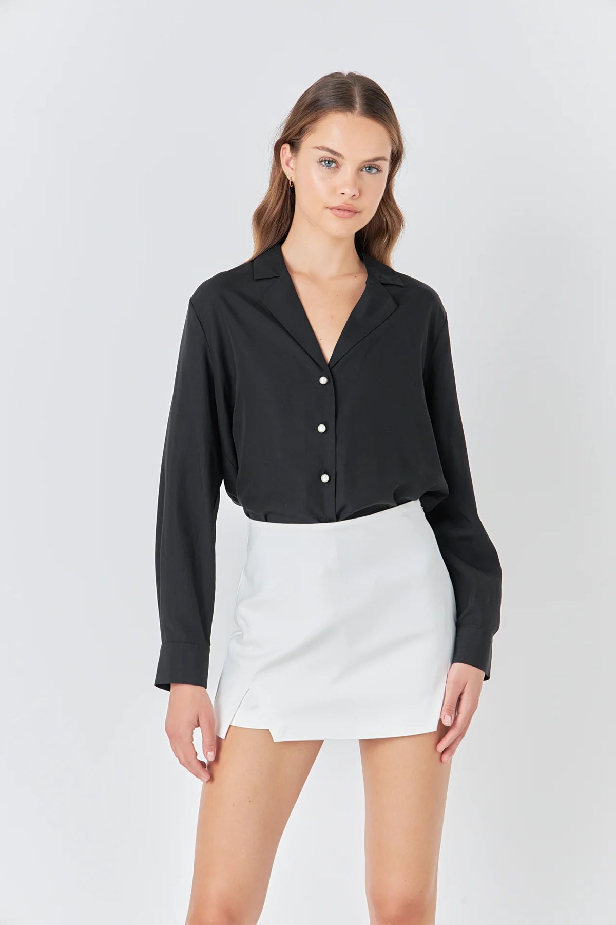 Discover the perfect balance of comfort and style with our trendy Pearl Button Collared Shirt. Made with soft and durable Poplin fabric, this long sleeve shirt offers a relaxed fit that hugs your body in all the right places. The V neckline adds a touch of elegance and enhances your silhouette, making it a versatile piece for any occasion. With its neutral pearl buttons, this shirt exudes charm and grace. Shop now and elevate your wardrobe with this must-have essential.
Don't forget to hand wash cold and a