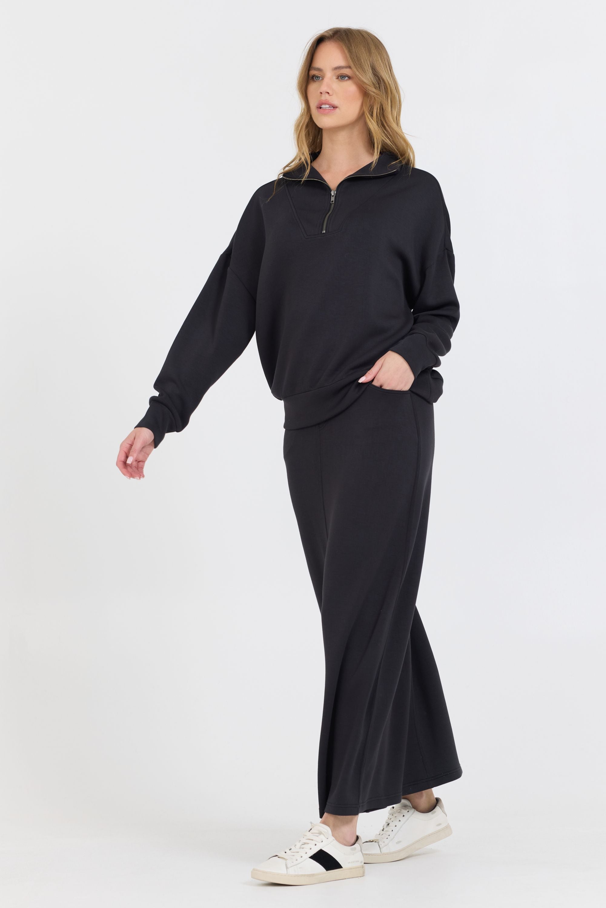Constructed with a blend of 49% Modal, 45% Polyester, and 6% Spandex, the Black Cloud Fleece Maxi Skirt boasts an ankle-length design that adds a slimming touch to your cozy ensemble.