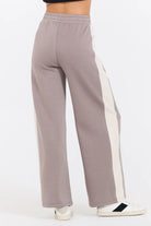 This Taupe/South Beach Sand Colorblock Cloud Fleece Pant features a bold stripe down the side, providing a unique touch to your daily casual attire. It is expertly made with a blend of 49% Modal, 45% Polyester, and 6% Spandex for ultimate comfort and style.