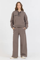 The Taupe Grey Fleece Hoodie with Flocking Detail is made of a blend of 49% Modal, 45% Polyester, and 6% Spandex. This unique fabric combination provides a comfortable and durable hoodie with a stylish flocking detail on the hood.