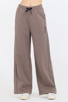 Constructed from a 49% Modal, 45% Polyester, and 6% Spandex blend, the Taupe Grey Fleece Pants with Flocking Detail offer a perfect combination of comfort and style.