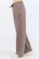 Constructed from a 49% Modal, 45% Polyester, and 6% Spandex blend, the Taupe Grey Fleece Pants with Flocking Detail offer a perfect combination of comfort and style.