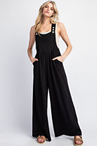 This solid jumpsuit is sleeveless with a square neckline, button adjustable straps, and one front bib pocket. The added pleats provide extra detail, and there are two side hip pockets. It is designed with a wide leg and made of 93% polyester and 7% spandex. This jumpsuit comes in black.