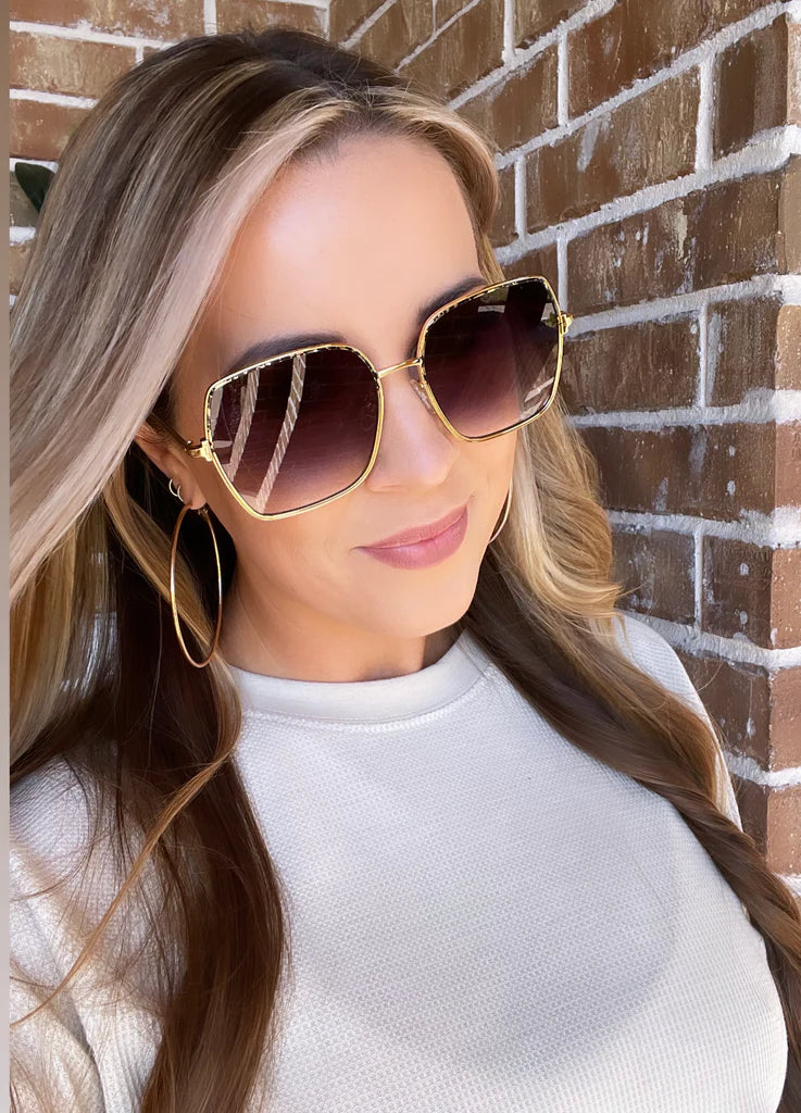 Enhance your style with Aspen sunglasses. The gold frame with speckles adds a touch of sophistication, while the ombre lens creates a flattering shape for any face. Ideal for those looking to make a statement.

Each pair comes with a DAX Eyewear box, storage pouch, and cleaning wipe.

Specifications: Frame Size: Large; Frame: Metal; Non-Polarized; UV Protection Coating; Lens width: 61mm; Lens height: 56mm.