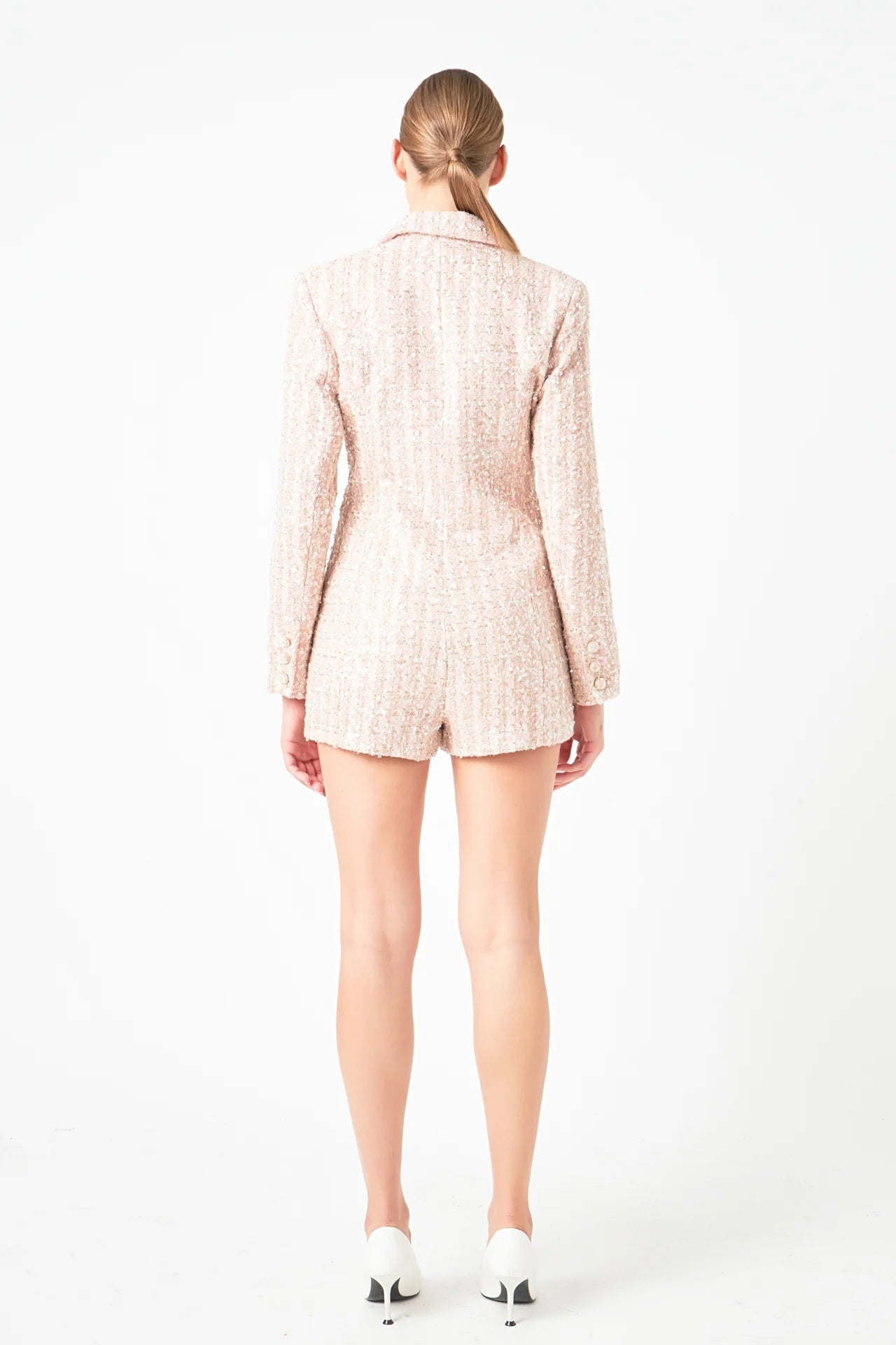 This Sequins Tweed Romper boasts a stunning design, featuring Double-Breasted style Skinny Lapels and Long Sleeves. The intricate tweed fabric is adorned with sequins for a dramatic touch. A must-have for any fashion enthusiast looking to make a statement, this romper can be worn to formal or semi-formal events, sure to attract admiration.

&nbsp;Embellished with sequins, this garment is made for Shoulder pads Decorative front pocket flaps, a Hidden interior button, and a Front button closure, with a Side z