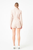 This Sequins Tweed Romper boasts a stunning design, featuring Double-Breasted style Skinny Lapels and Long Sleeves. The intricate tweed fabric is adorned with sequins for a dramatic touch. A must-have for any fashion enthusiast looking to make a statement, this romper can be worn to formal or semi-formal events, sure to attract admiration.

&nbsp;Embellished with sequins, this garment is made for Shoulder pads Decorative front pocket flaps, a Hidden interior button, and a Front button closure, with a Side z