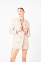 This Sequins Tweed Romper boasts a stunning design, featuring Double-Breasted style Skinny Lapels and Long Sleeves. The intricate tweed fabric is adorned with sequins for a dramatic touch. A must-have for any fashion enthusiast looking to make a statement, this romper can be worn to formal or semi-formal events, sure to attract admiration.

&nbsp;Embellished with sequins, this garment is made for Shoulder pads Decorative front pocket flaps, a Hidden interior button, and a Front button closure, with a Side z