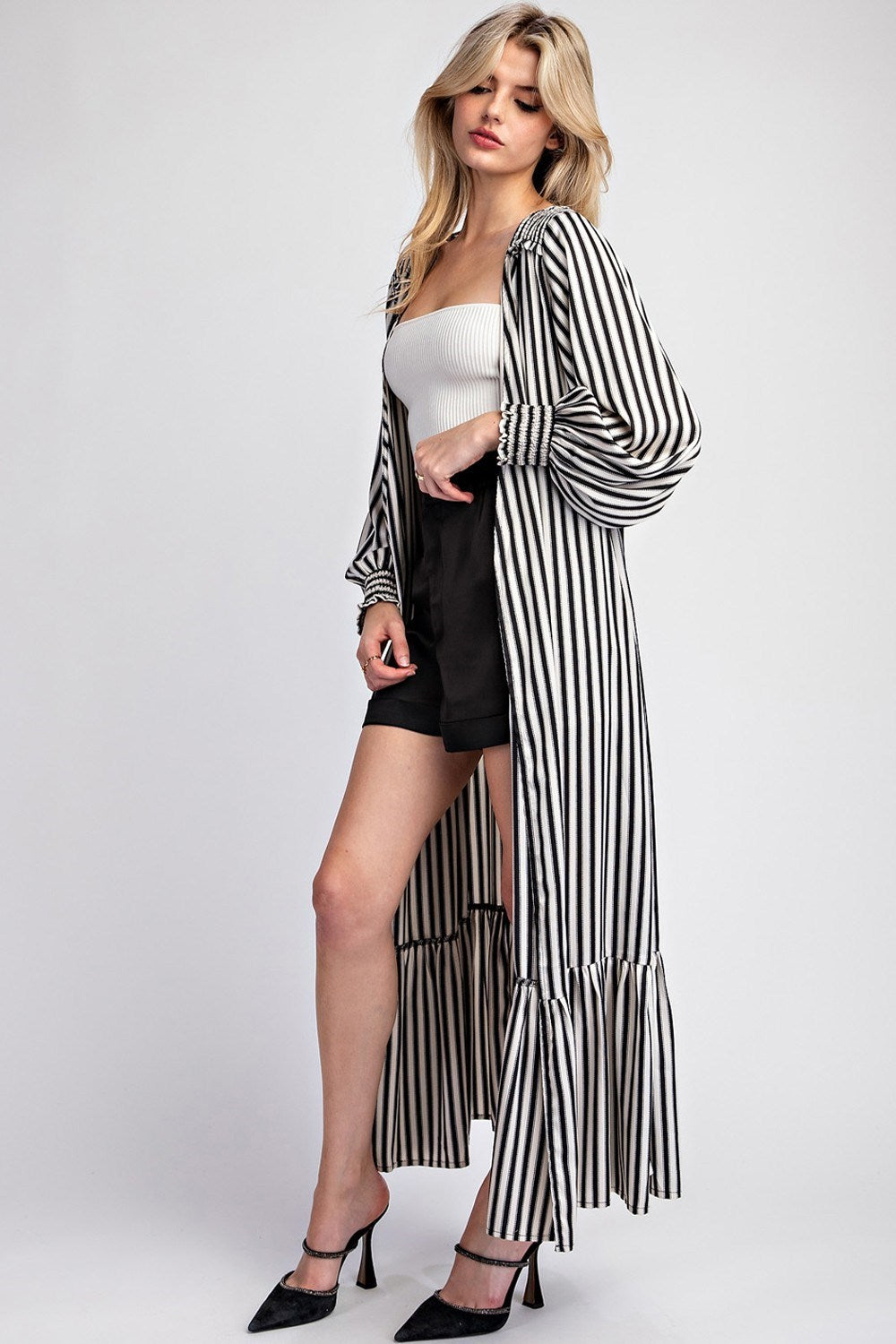 This Striped Long Sleeve Maxi Kimono boasts an open front design with smocked shoulders and cuffs, as well as belt loops and a tie waist closure. Made with a flowy fabrication, it is constructed with 100% polyester for a comfortable and stylish fit.