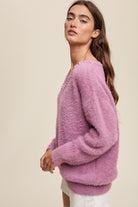 The Deep V-Neck Peal Detail Fuzzy Knit Sweater is composed of a soft touch Fuzzy Knit material, featuring a deep V-neckline and delicate pearl detailing. It boasts long sleeves and is finished with ribbed accents on the neck, cuffs and hem. Made of 65% acrylic and 35% polyester, this sweater is available in a lovely Lilac hue.