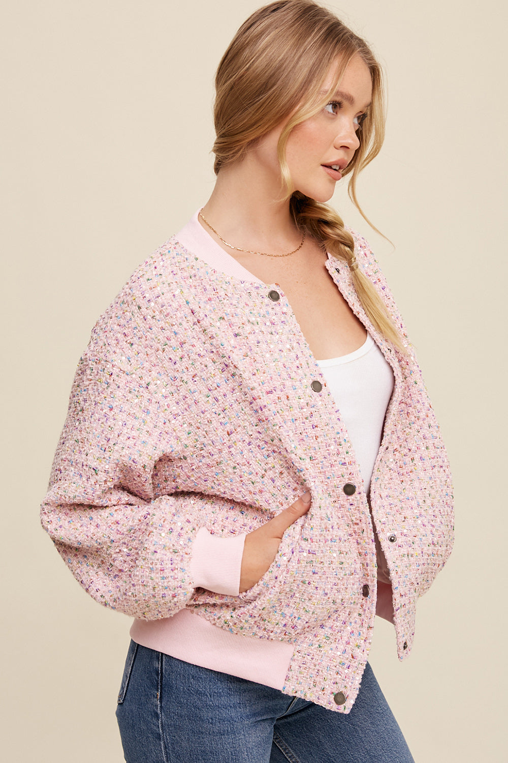 This bomber jacket is crafted with tweed and adorned with sparkling sequins. The center front features snap buttons, while the neck, cuffs, and hem are ribbed. It also has long sleeves and front pockets. The entire jacket is lined with 100% polyester, making it a stylish and comfortable choice.