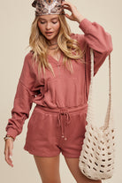 Expertly crafted from 100% cotton, this French terry hoodie romper features a low V neckline and long sleeves with elastic bands on the openings. The adjustable strap with elastic band on the waistband provides a comfortable fit, while the pocket on the side front bottom shorts adds functionality. This piece is completed with a clean hem and is available in a rich Deep Rose color.