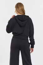 Crafted from 49% Modal, 45% Polyester, and 6% Spandex, the Black Cloud Fleece Crop Zip Up boasts an ultra-soft texture for unparalleled comfort.