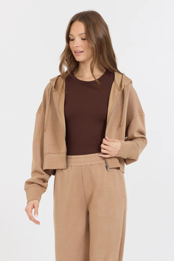 This Caramel Cloud Fleece Crop Zip Up showcases a blend of 49% Modal, 45% Polyester, and 6% Spandex, making it the perfect balance of softness and stretch. The zip up design adds convenience, while the cloud fleece material provides ultimate comfort.