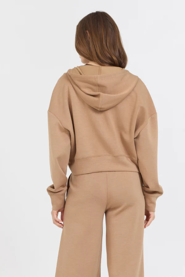 This Caramel Cloud Fleece Crop Zip Up showcases a blend of 49% Modal, 45% Polyester, and 6% Spandex, making it the perfect balance of softness and stretch. The zip up design adds convenience, while the cloud fleece material provides ultimate comfort.