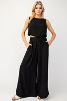 Expertly designed with a 100% polyester construction, these solid wide leg pants offer ultimate comfort with an added elastic band at the back. Complete with two side hip pockets and a pinched design, these pants are perfect for any occasion.